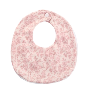 Close-up of pink floral pattern baby bib with white resin snap button closure