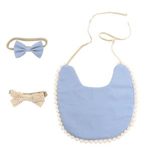 Close-up of sky blue bamboo cotton baby bib set with lace floral headbands and pompom trim