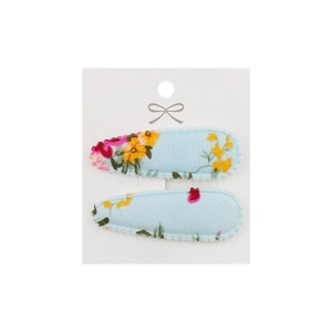 Detail of floral embroidery on light blue fabric hair clips set with wavy edge stitching