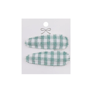 Close-up of green and white checkered floral fabric hair clips on display card