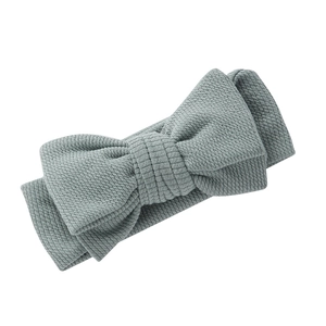 Détail du bandeau pour bébé en tissu côtelé bleu gris avec un grand nœud