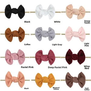 Variety of 12 waffle fabric bow headbands for babies in assorted vibrant colors