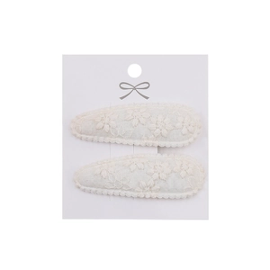 Detailed close-up of cream lace floral embroidery on water drop-shaped hair clips for girls