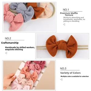 Detail of handmade waffle fabric baby headbands showing breathable texture and bow design
