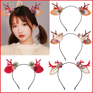 Detail of Christmas reindeer antler headband featuring sequins, pom-poms, and mini mushrooms