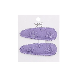 Close-up of light purple floral embroidery on fabric covered water drop hair clips