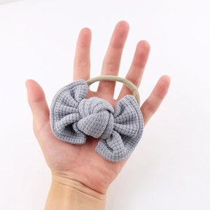 Detail showing the gray waffle-knit texture bow and high-elastic nylon baby headband