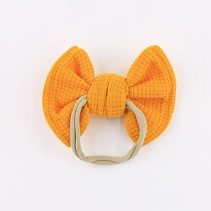 Yellow waffle bow baby headband with high-elastic nylon band on white background