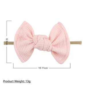 Pink waffle texture bow headband for infants with high elastic nylon strap for soft comfort