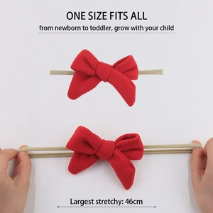 Elastic baby headband with red faux cashmere bow showing high stretchability for newborns