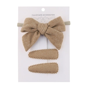 Detailed set of handmade earth-tone fabric bow headband and two oval hair clips