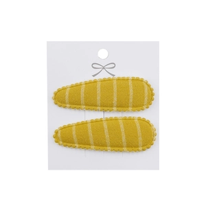 Detailed view of yellow striped fabric snap clips on a display card for toddlers
