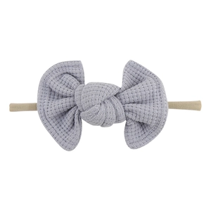 Detail showing light purple waffle fabric bow texture on elastic nylon baby headband