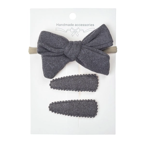 Detailed set of three handmade dark grey fleece bow headband and hair clips for infants