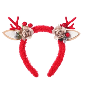 Detailed view of red reindeer antlers headband with champagne fabric flowers and berries
