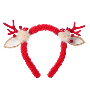 Detail of Christmas reindeer antler headband with red berries and mushroom decor