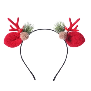 Detail of red Christmas antler headband with green pine needles and small mushrooms