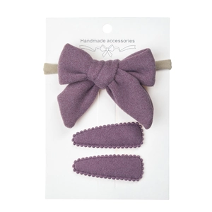 Detailed set of violet cashmere bow headband and wavy edge clips on white card
