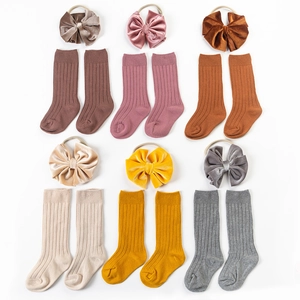 Detail of 6-piece baby ribbed cotton socks and velvet bow headband set in various colors