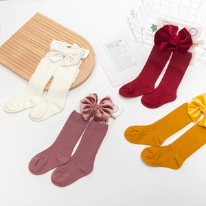 Detailed set of combed cotton baby socks and velvet bow headbands in four soft colors