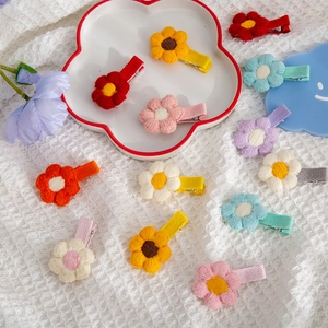 Detail of colorful knitted floral hair clips with metal alligator base for kids