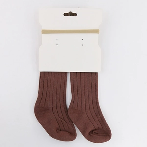 Detail view of infant ribbed knit socks and matching headband set on display packaging