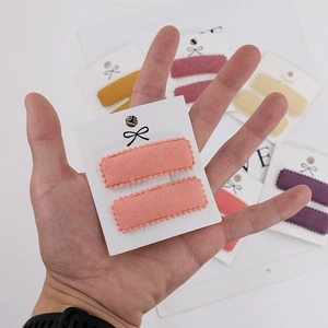 Detailed close-up of textured fabric square BB hair clips in various Morandi colors