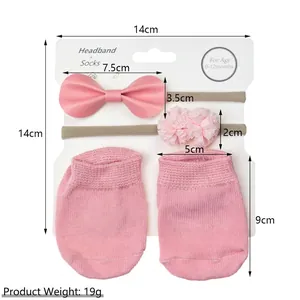 Pink infant bow headband and non-slip socks gift set on display card with measurements