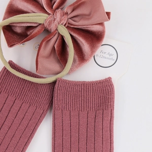 Detail of baby set with velvet bow headband and ribbed socks for 0-12 months