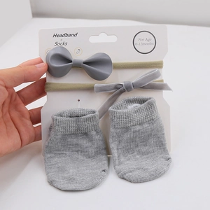 Gray baby socks and headband set for infants aged 0-12 months in gift packaging