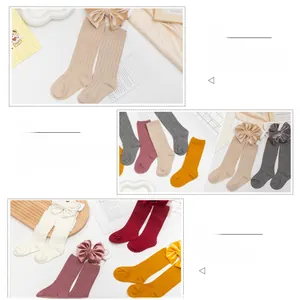 Detailed view of combed cotton children's socks and velvet bow headband gift set