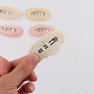 Detail of pink and cream lace BB hair clips with metal back and felt protective lining