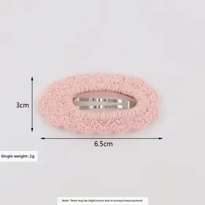 Detail showing pink knitted lace hair clip with 6.5cm length and BB clip texture