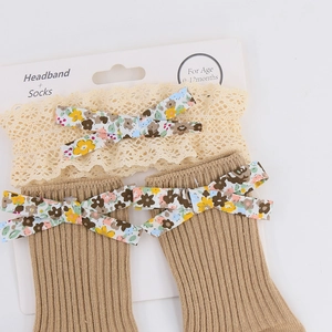 Detail view of baby lace headband and floral bow socks set for infants 0-12 months