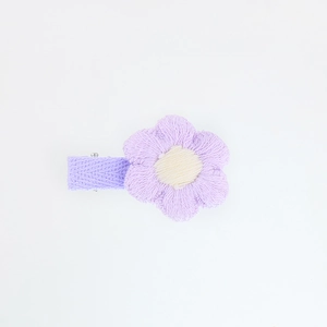 Close-up of handmade purple embroidered six-petal flower hair clip with 3D texture