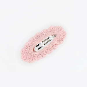 Close-up of pink knitted cotton hair clip with scalloped edge and silver BB clip