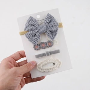 Detailed close-up of 4-piece grey knit and lace hair accessories set for kids