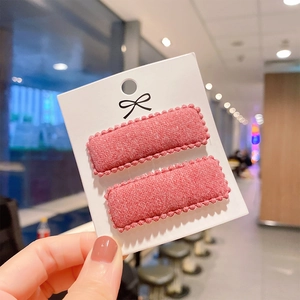 Close-up of two dusty pink cashmere-style square BB hair clips with bead edges on card