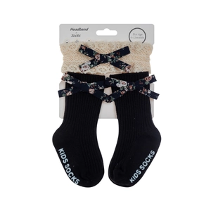 Detail of baby lace headband and floral bow socks on product display card