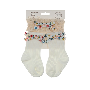 Close-up of baby lace headband and cotton socks set with floral bows and anti-slip grip