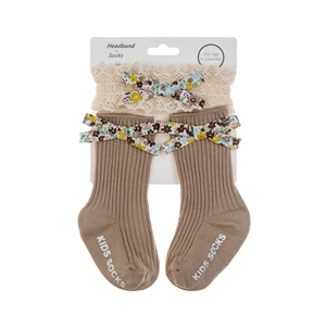 Detail of anti-slip rubber grips on baby socks with matching lace headband set