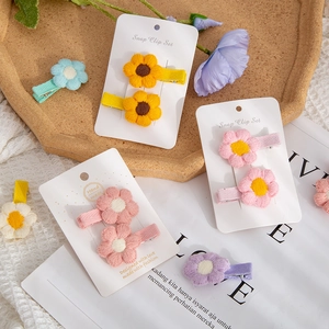 Handmade crochet flower hair clips set for girls featuring vibrant knitted floral designs