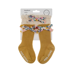 Close-up of ginger ribbed baby socks and lace headband set with floral bows for 0-12 months