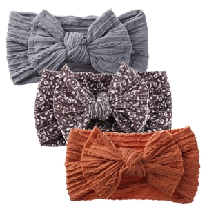 Three-piece set of baby bow headbands featuring soft cable knit and floral print fabrics
