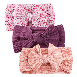 Three-pack soft baby bow headbands featuring floral patterns and knit textures