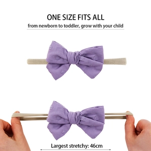 Purple bow baby headband with stretchy nylon strap showing un-stretched and stretched states