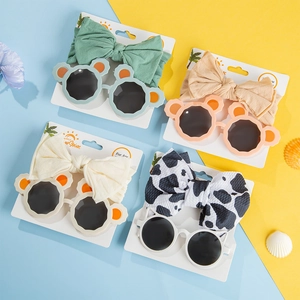 Detailed set of baby knit bow headbands and cute cartoon bear-shaped sunglasses for children