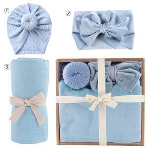 Newborn 3-piece set with light blue swaddle, knotted hat, and bow headband in a gift box