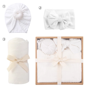 Newborn baby white swaddle blanket set with knot hat and bow headband in a gift box
