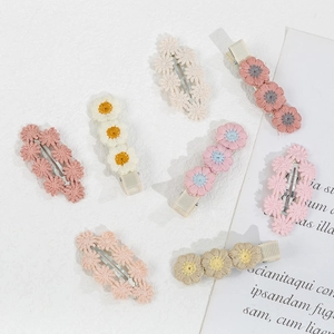 Detailed close-up of seven handmade floral embroidery hair clips for girls in Morandi colors